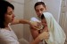 Carlos Heredia, and his wife Veronica give their youngest daughter a bath.